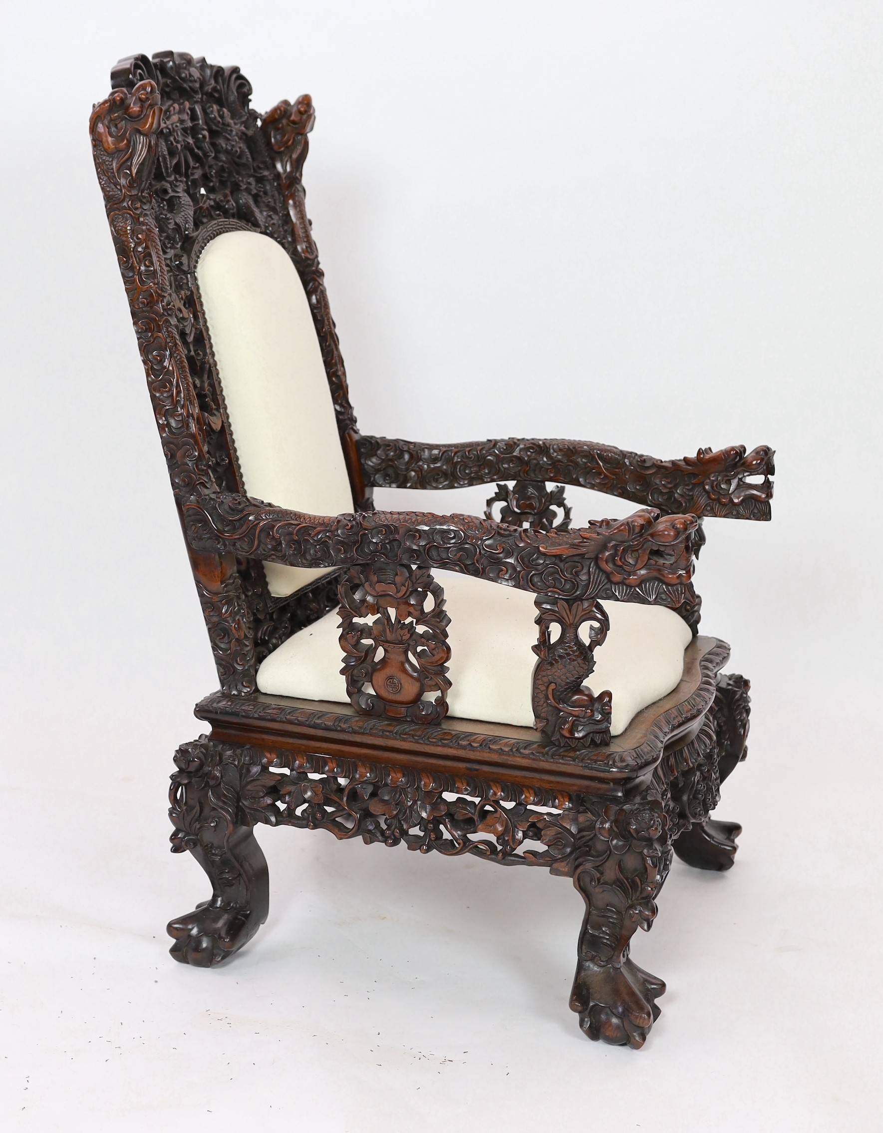 A good Chinese hardwood ‘dragon’ throne armchair, c.1900, 114.5cm high, 68cm wide at the arms